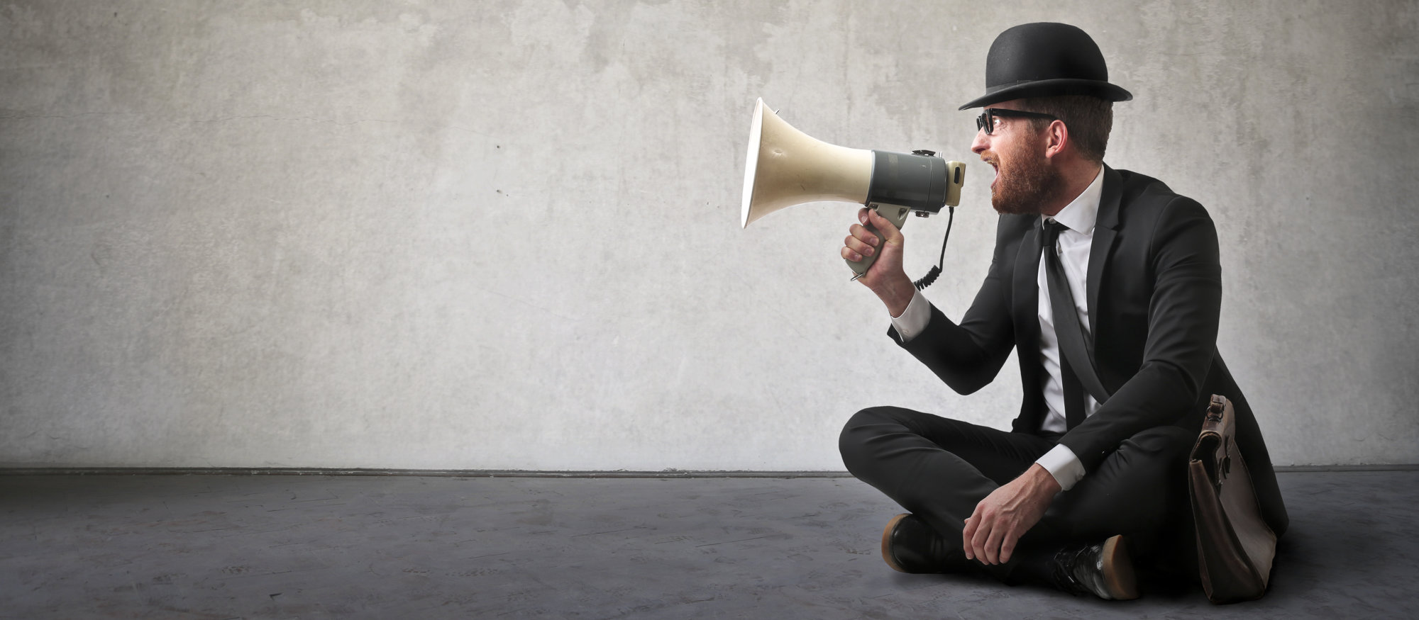 Vintage looking man shouting with a megaphone