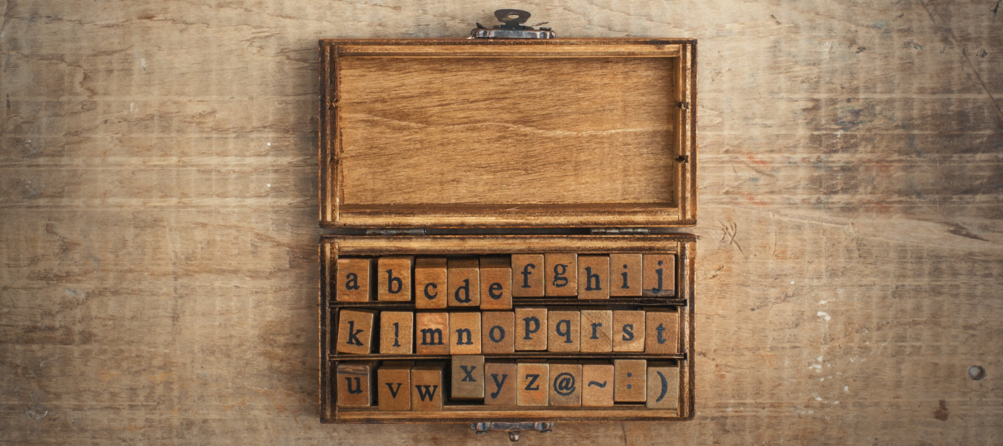 wooden stamps alphabet in old vintage box on grunge background