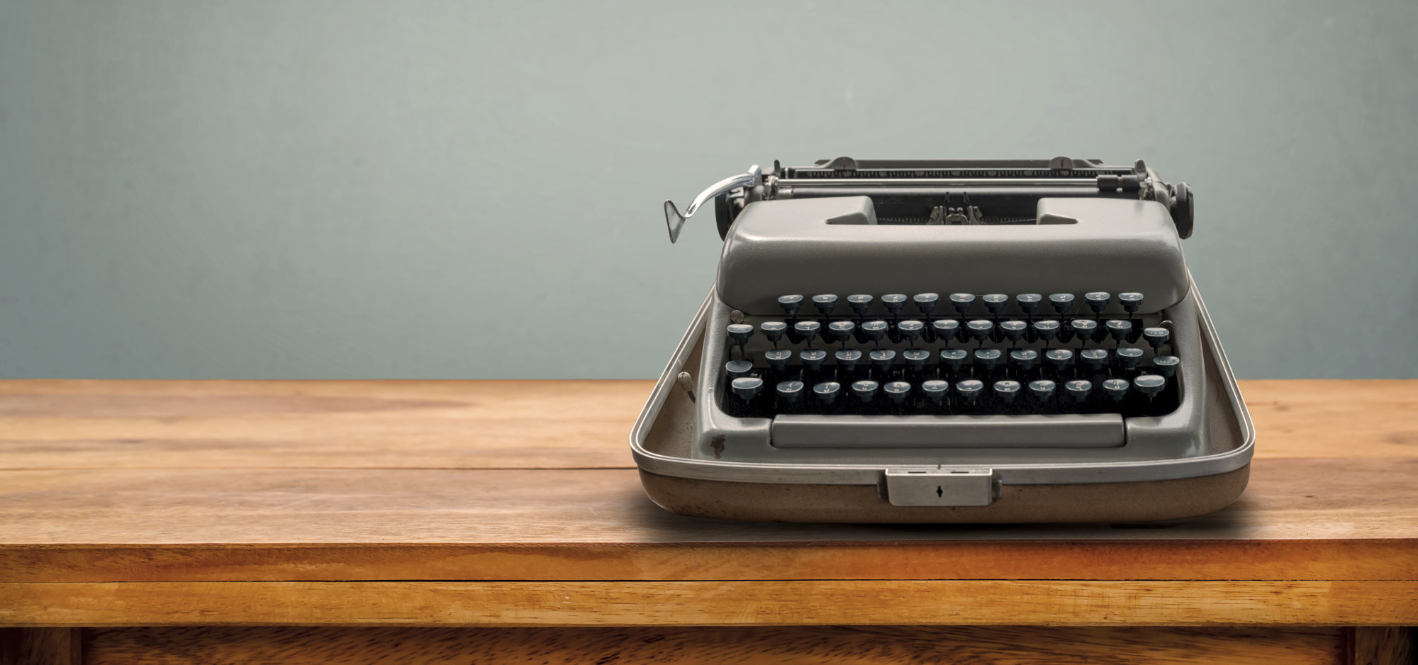 Old retro Typewriter on table with vintage gray gradient background